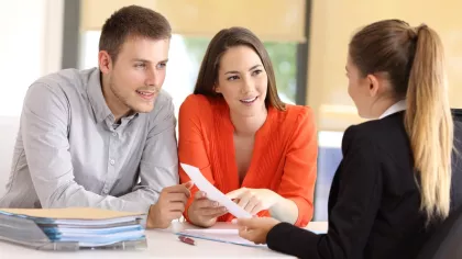 Two customers working with a financial rep