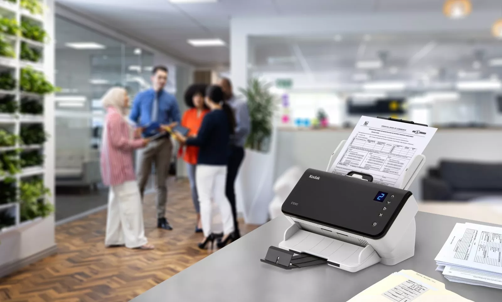 Employees gathered around a scanner