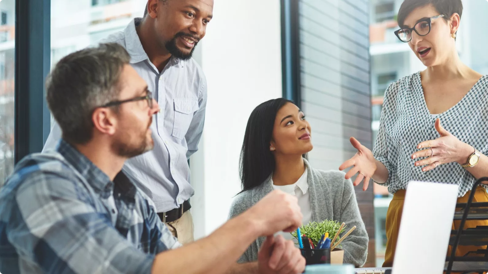 4 colleagues gathered together at work