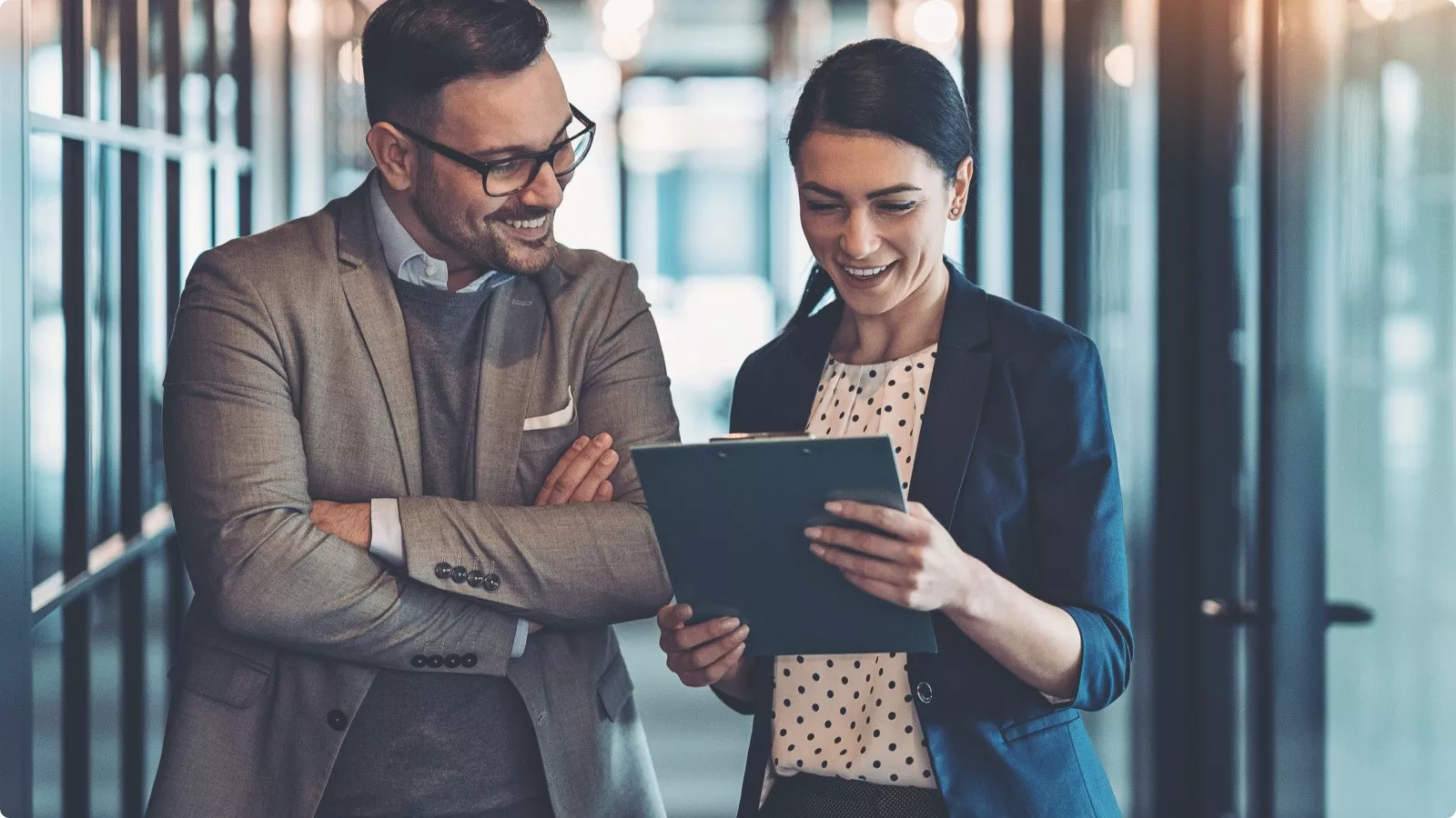 Two employees looking at a clipboard